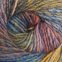 Close-up of a ball of multicolored yarn with shades of blue, mustard, grey, purple, and orange.