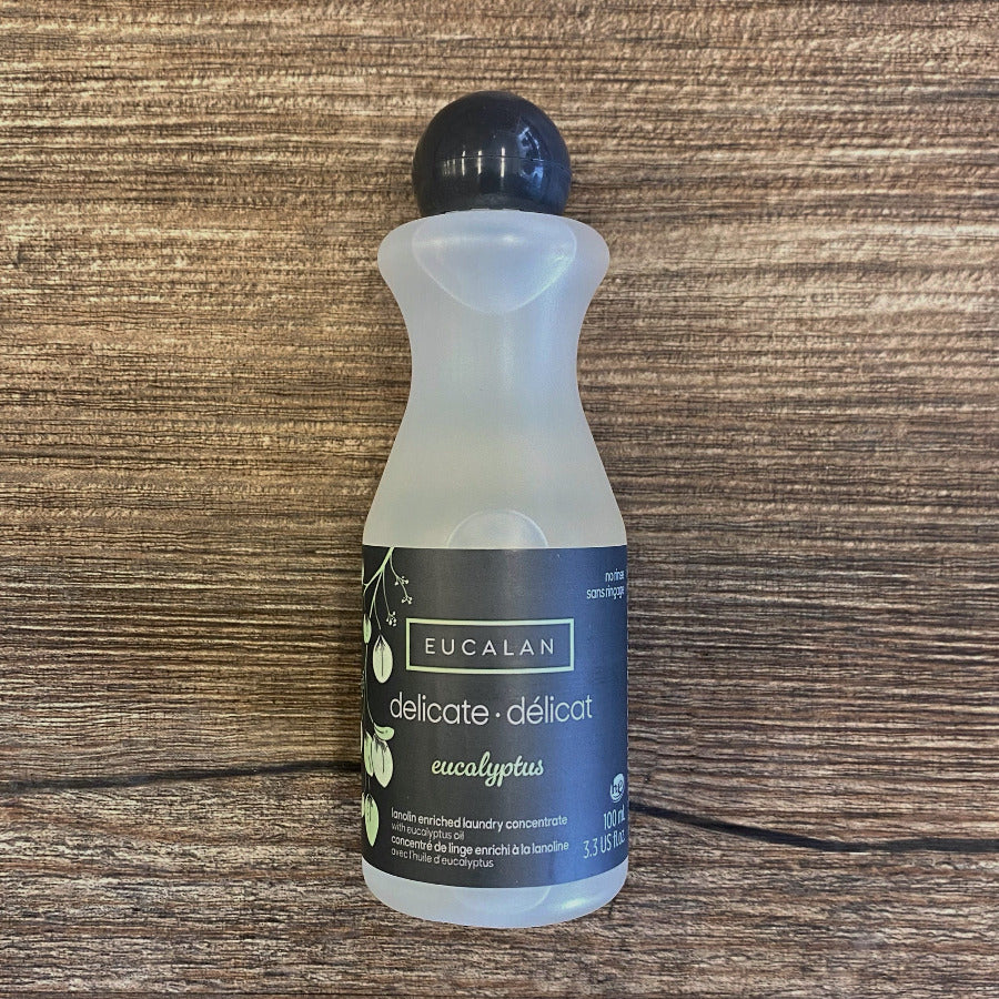 Bottle of Eucalan laundry detergent on a wooden surface