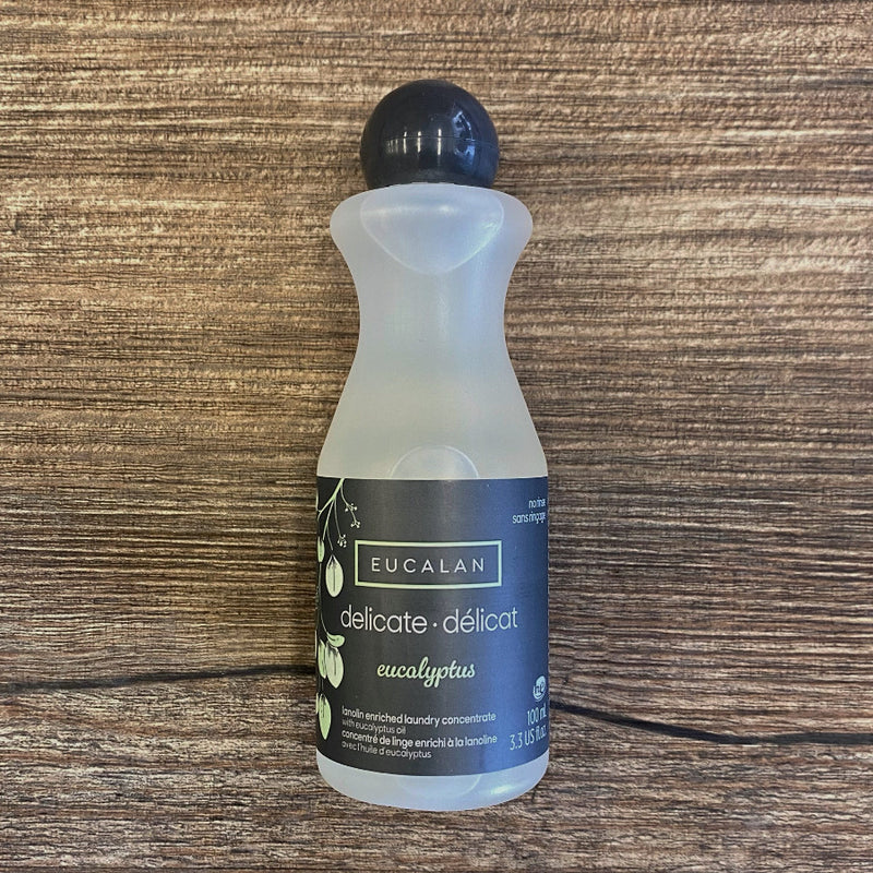 Bottle of Eucalan laundry detergent on a wooden surface