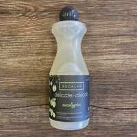 Bottle of Eucalan delicate laundry detergent on a wooden surface