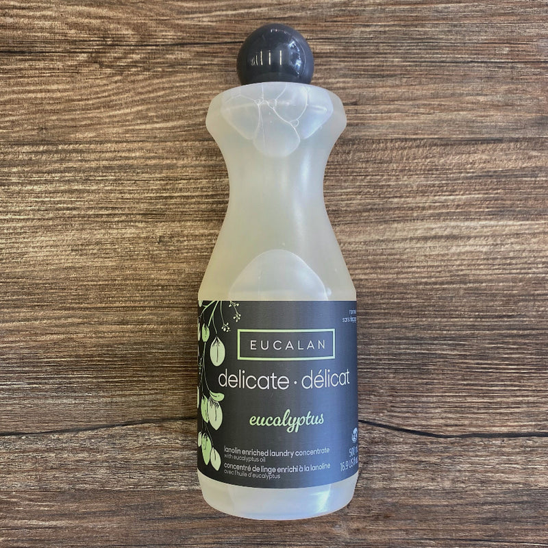 Bottle of Eucalan delicate laundry detergent on a wooden surface
