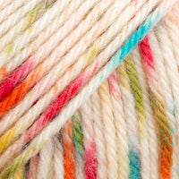 Close-up of white yarn with red, green, blue, yellow, and orange speckles.