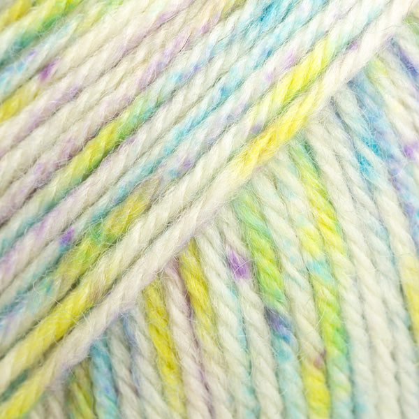 Close-up of white yarn with pastel blue, yellow, and purple speckles