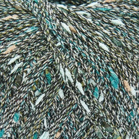 Close-up of a multicoloured textured yarn with shades of grey, teal, tan, and white