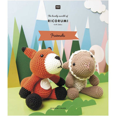 Crocheted fox and bear sitting together with a colorful forest background, in a book featuring Ricorumi branding.