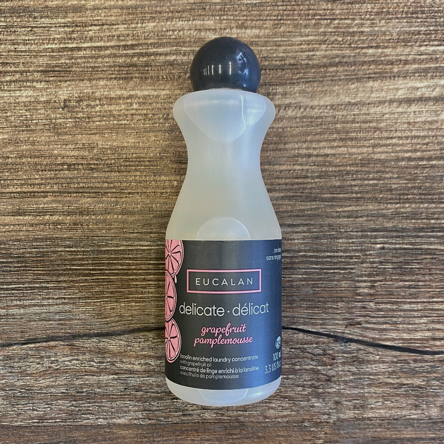 Bottle of Eucalan delicate detergent on a wooden surface