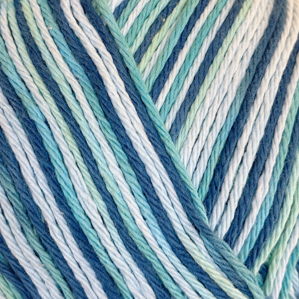 Close-up of variegated yarn in shades of mint, navy, blue, and white