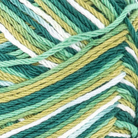 Close-up of multicolored yarn with green, yellow, and white hues.