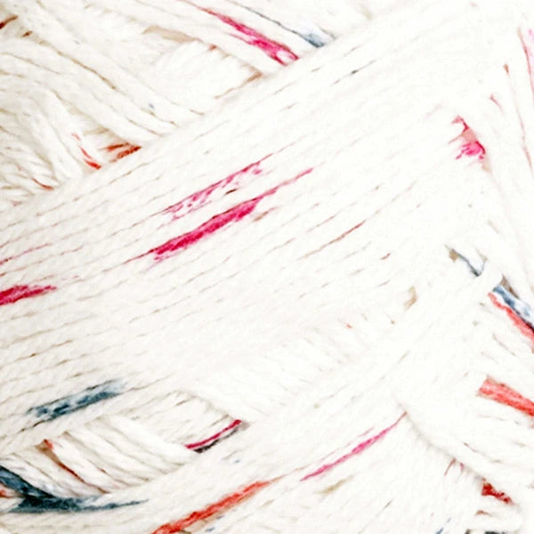 Close-up of a white ball of yarn with multi color speckles