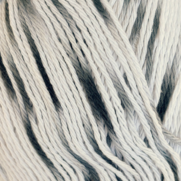 Close-up of white cotton yarn with soft black speckles
