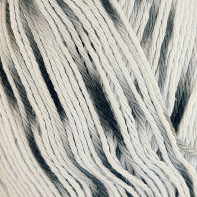 Close-up of white cotton yarn with soft black speckles