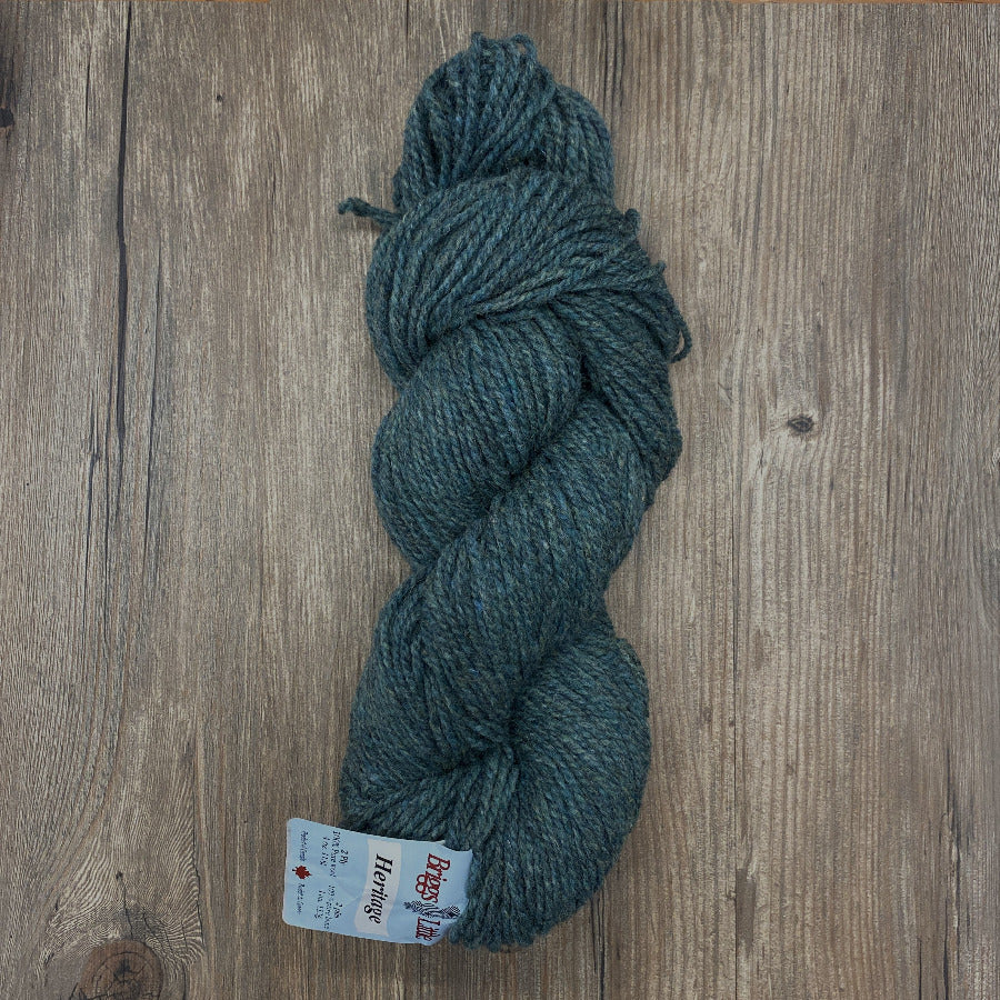 Green skein of yarn with a label on a wooden surface