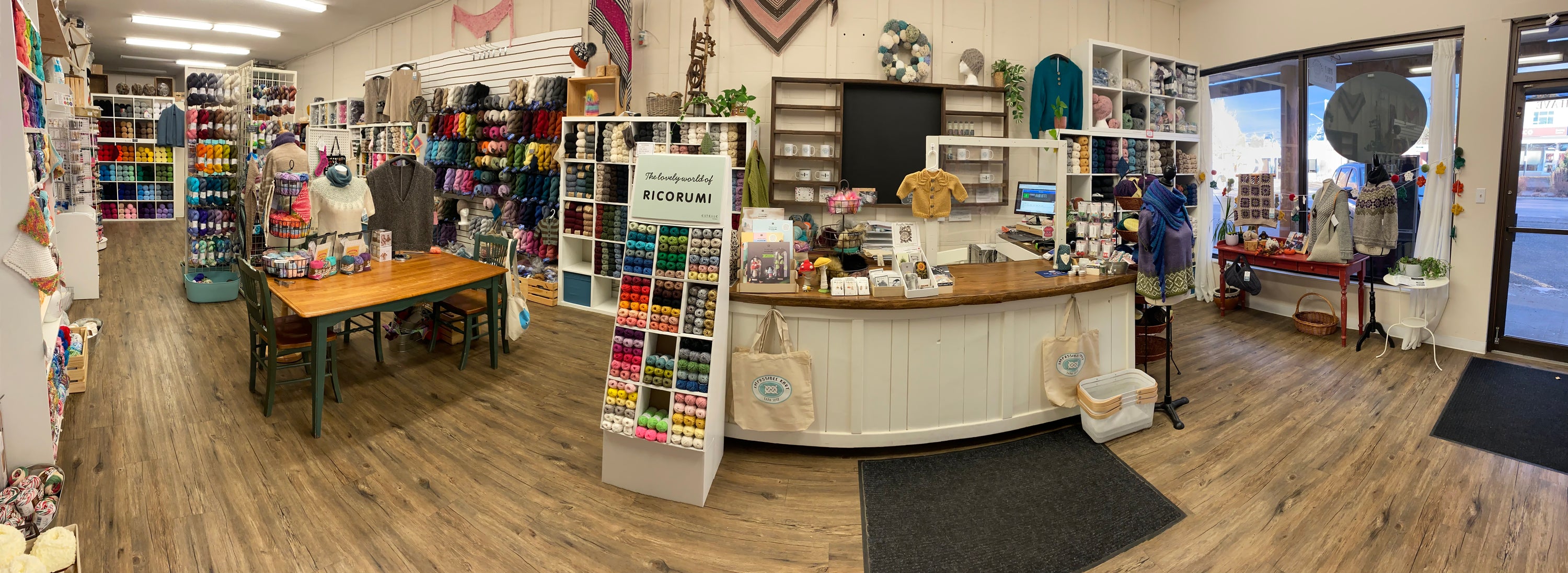 Interior of a yarn store with various yarn products and furniture