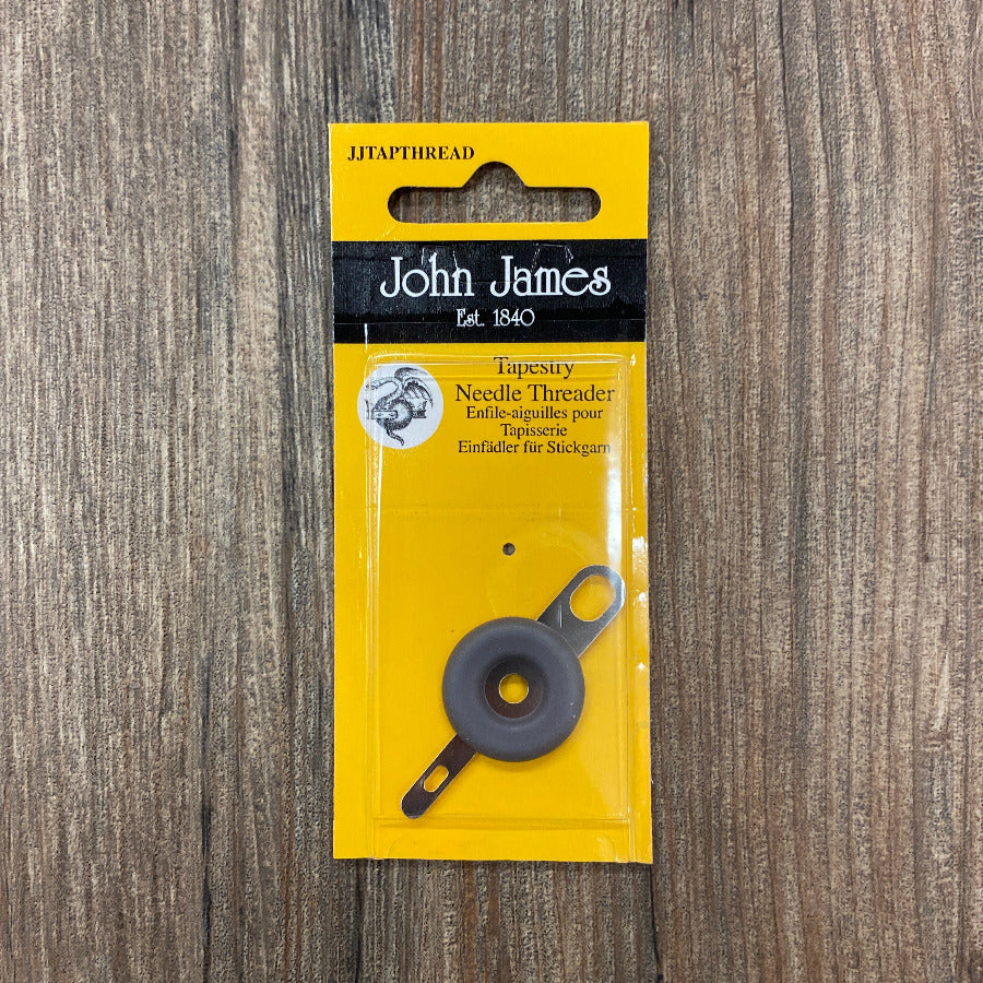 John James needle threader packaging on a wooden surface