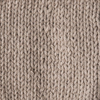 Close-up of a textured beige knitted fabric 