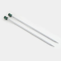 Shiny silver metal needles with green wooden ends on a white background
