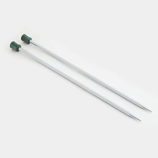 Shiny silver metal needles with green wooden ends on a white background
