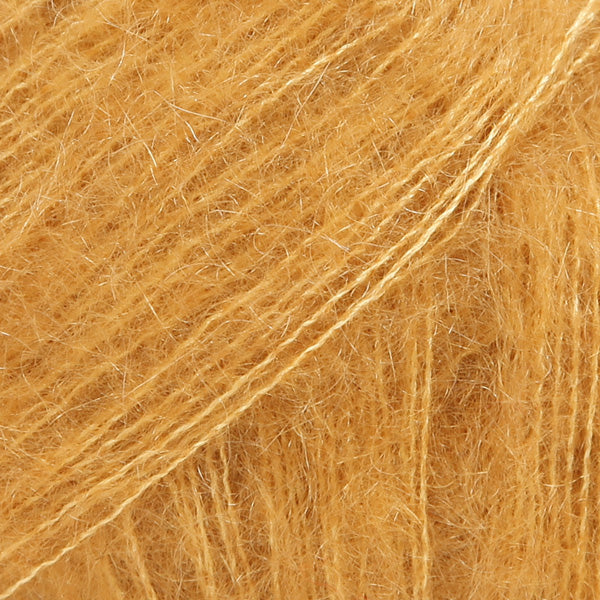 Close-up of mustard coloured lace yarn
