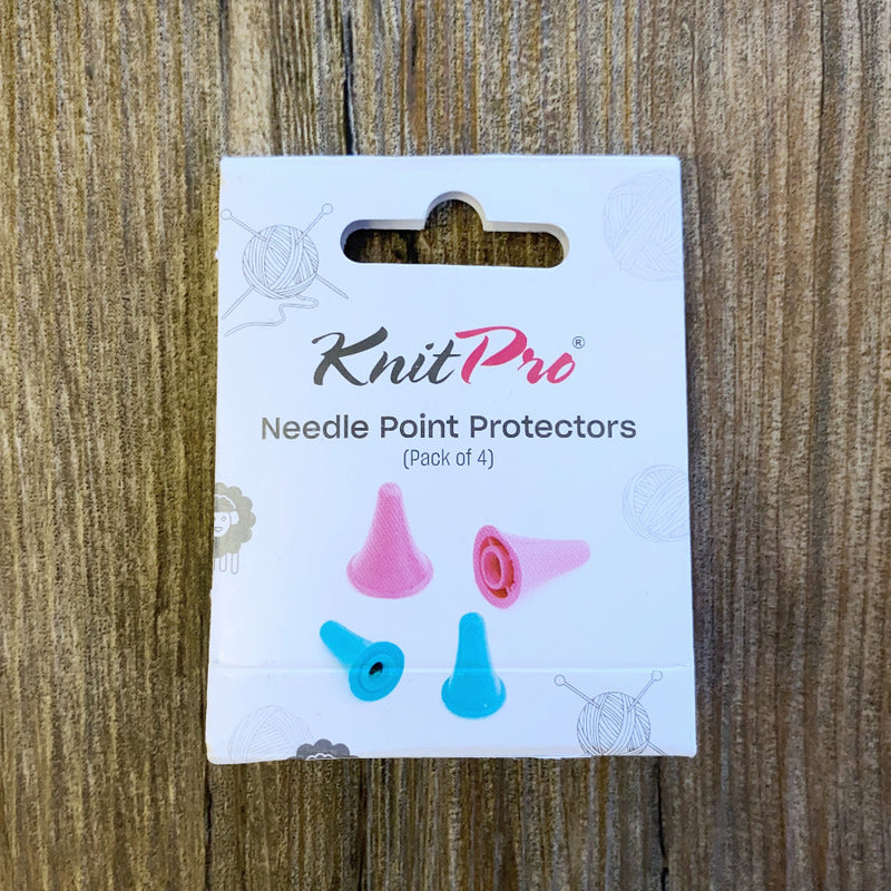 Pack of KnitPro needle point protectors on a wooden surface