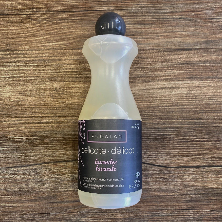 Bottle of Eucalan delicate detergent on a wooden surface