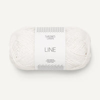 Ball of white yarn with Sandnes Garn label on a white background