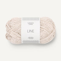 Ball of off white yarn with a label on a white background