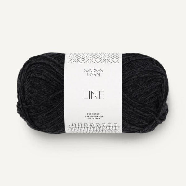 Black yarn ball with a label on a white background