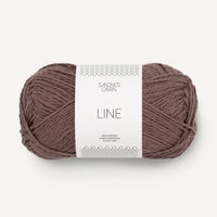 Ball of brown yarn with a label on a white background