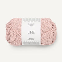 Pale pink yarn ball with a label on a white background
