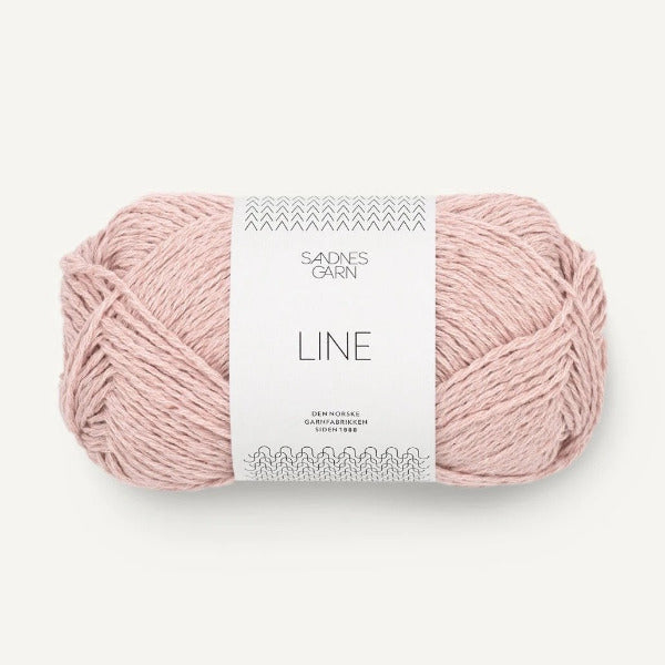 Pale pink yarn ball with a label on a white background