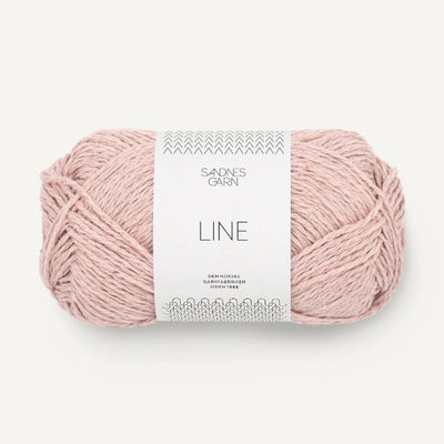 Pale pink yarn ball with a label on a white background
