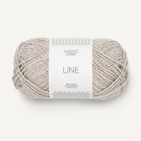 Ball of pale grey yarn with a label on a white background