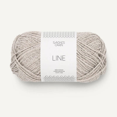 Ball of pale grey yarn with a label on a white background
