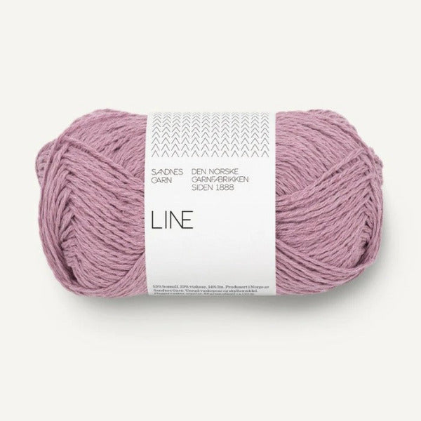 Ball of pinkish purple yarn with a white label on a white background