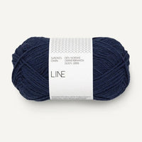Dark blue skein of yarn with a label on a white background