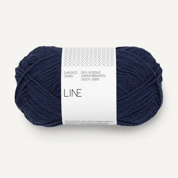 Dark blue skein of yarn with a label on a white background
