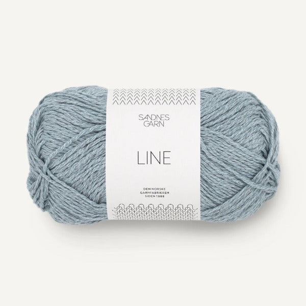 Ball of light blue yarn with a label on a white background
