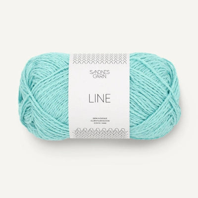 Turquoise skein of yarn with a label on a white background