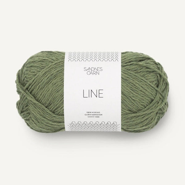 Green skein of yarn with a label on a white background