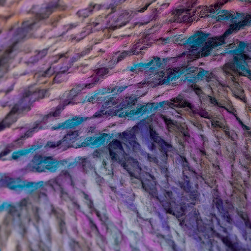 Close-up of purple, blue, brown, and pink yarn ball
