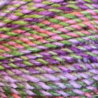 Close-up of multicolored yarn with shades of pink, green, and purple.