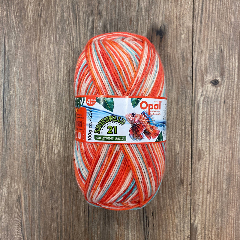 Ball of multicoloured yarn with Opal label on a wooden surface