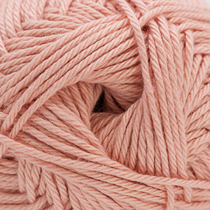 Close-up of light peach pink yarn ball.
