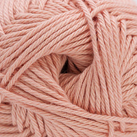 Close-up of light peach pink yarn ball.