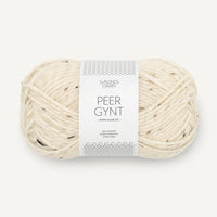 Ball of cream tweed yarn with a label on a white background