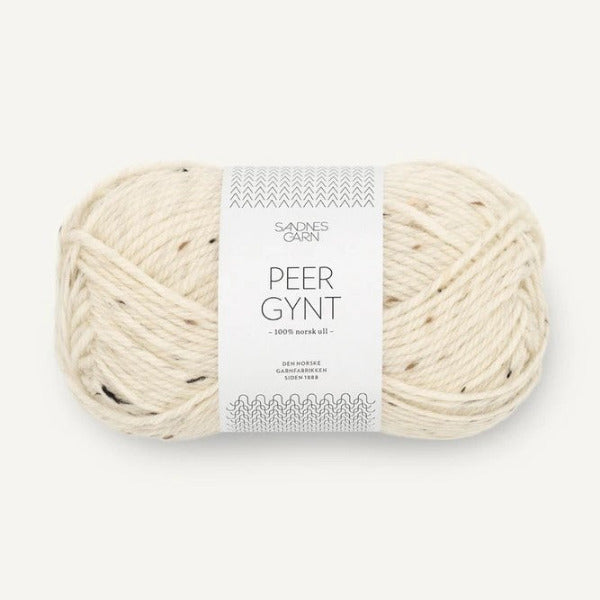 Ball of cream tweed yarn with a label on a white background