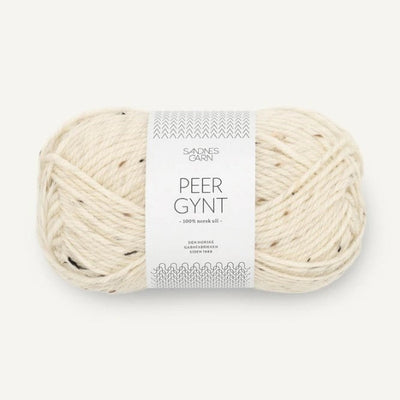 Ball of cream tweed yarn with a label on a white background