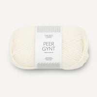 Ball of white yarn with a label on a white background