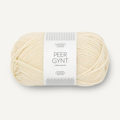 Ball of cream yarn with a label on a white background