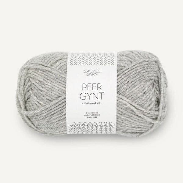 Ball of light grey yarn with a label on a white background